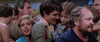 Movie still from “Jaws 3-D” (1983), directed by Joe Alves – A man and a little girl hugging each other; Close Up shot, Over the shoulder angle
