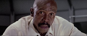 Movie still from “Jaws 3-D” (1983), directed by Joe Alves – An older man with a mustache looking at the camera; Close Up shot, Low angle