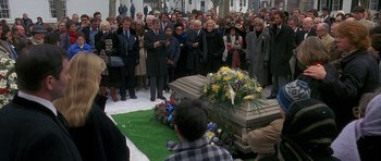 Movie still from “Jaws: The Revenge” (1987), directed by Joseph Sargent – A crowd of people standing around a casket; Wide shot, High angle