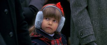 Movie still from “Jaws: The Revenge” (1987), directed by Joseph Sargent – A little girl wearing ear muffs and a plaid jacket; Close Up shot, Over the shoulder angle