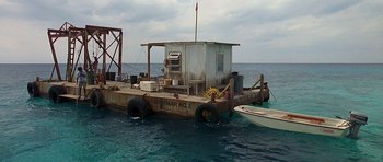 Movie still from “Jaws: The Revenge” (1987), directed by Joseph Sargent – An old boat is docked in the water; Extreme Wide shot, High angle