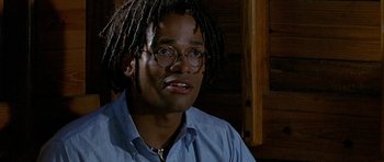 Movie still from “Jaws: The Revenge” (1987), directed by Joseph Sargent – A person wearing glasses and a blue shirt; Close Up shot, Low angle