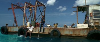 Movie still from “Jaws: The Revenge” (1987), directed by Joseph Sargent – Two people on a boat in the water; Wide shot, High angle