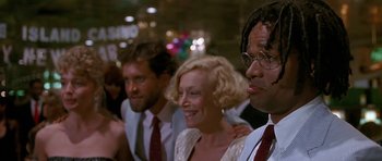 Movie still from “Jaws: The Revenge” (1987), directed by Joseph Sargent – A group of people standing next to each other in a room; Close Up shot, Over the shoulder angle