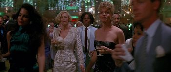 Movie still from “Jaws: The Revenge” (1987), directed by Joseph Sargent – A group of people standing in front of a crowd holding wine glasses; Medium shot, Low angle