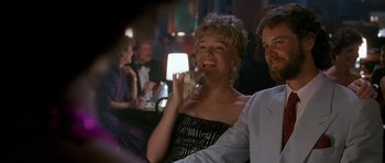 Movie still from “Jaws: The Revenge” (1987), directed by Joseph Sargent – A man and a woman sitting at a table; Close Up shot, Over the shoulder angle