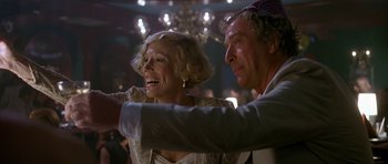 Movie still from “Jaws: The Revenge” (1987), directed by Joseph Sargent – A man and a woman are smiling at the camera; Close Up shot, Low angle