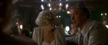 Movie still from “Jaws: The Revenge” (1987), directed by Joseph Sargent – A man and a woman laughing together in a restaurant; Close Up shot, Over the shoulder angle