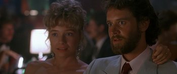 Movie still from “Jaws: The Revenge” (1987), directed by Joseph Sargent – A man and a woman standing next to each other; Close Up shot, Low angle