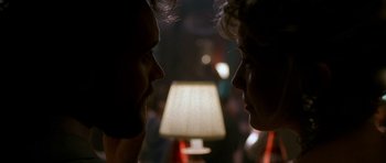 Movie still from “Jaws: The Revenge” (1987), directed by Joseph Sargent – A couple of people that are staring at each other; Extreme Close Up shot, Over the shoulder angle