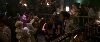 Movie still from “Jaws: The Revenge” (1987), directed by Joseph Sargent – A group of young people dancing in a room; Wide shot, Over the shoulder angle