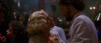 Movie still from “Jaws: The Revenge” (1987), directed by Joseph Sargent – A man and a woman laughing together in a room; Close Up shot, Low angle