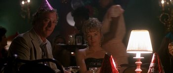 Movie still from “Jaws: The Revenge” (1987), directed by Joseph Sargent – A woman sitting at a table with a glass of wine; Close Up shot, Over the shoulder angle
