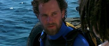 Movie still from “Jaws: The Revenge” (1987), directed by Joseph Sargent – A person wearing a wetsuit; Close Up shot, Over the shoulder angle