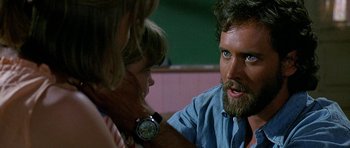 Movie still from “Jaws: The Revenge” (1987), directed by Joseph Sargent – A man with a beard is talking to a woman; Close Up shot, Over the shoulder angle