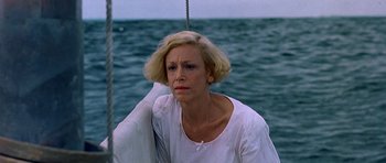 Movie still from “Jaws: The Revenge” (1987), directed by Joseph Sargent – A woman sitting on a sailboat in the water; Close Up shot, High angle