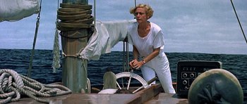 Movie still from “Jaws: The Revenge” (1987), directed by Joseph Sargent – A woman standing on the deck of a boat in the ocean; Medium shot, Low angle