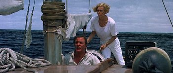 Movie still from “Jaws: The Revenge” (1987), directed by Joseph Sargent – An older woman standing next to an older man on a boat; Medium shot, Low angle