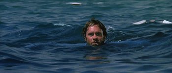 Movie still from “Jaws: The Revenge” (1987), directed by Joseph Sargent – A man in the water with his mouth wide open; Close Up shot, Low angle