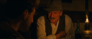 Movie still from “Jean de Florette” (1986), directed by Claude Berri – A man with a hat and a mustache talking to another man; Close Up shot, Over the shoulder angle