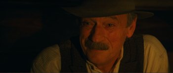 Movie still from “Jean de Florette” (1986), directed by Claude Berri – An older man with a mustache and a hat; Close Up shot, Over the shoulder angle