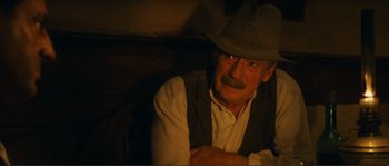 Movie still from “Jean de Florette” (1986), directed by Claude Berri – An old man with a mustache wearing a cowboy hat; Close Up shot, Over the shoulder angle