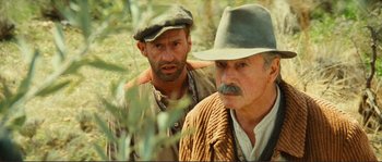 Movie still from “Jean de Florette” (1986), directed by Claude Berri – A man and a man with a hat and a beard; Close Up shot, Low angle