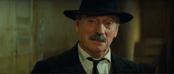 Movie still from “Jean de Florette” (1986), directed by Claude Berri – An older man wearing a hat and a tie; Close Up shot, Low angle