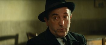 Movie still from “Jean de Florette” (1986), directed by Claude Berri – A person wearing a suit and a hat; Close Up shot, Low angle