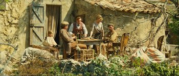 Movie still from “Jean de Florette” (1986), directed by Claude Berri – A group of people sitting at a table outside; Wide shot, High angle