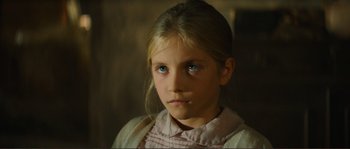 Movie still from “Jean de Florette” (1986), directed by Claude Berri – A young girl with blue eyes stares into the camera; Close Up shot, High angle