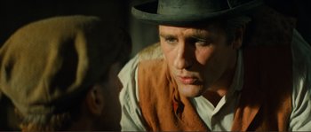 Movie still from “Jean de Florette” (1986), directed by Claude Berri – A man wearing a hat talking to another man; Close Up shot, Over the shoulder angle