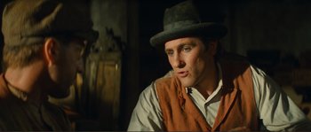 Movie still from “Jean de Florette” (1986), directed by Claude Berri – A man wearing a hat and a vest looking to his left; Close Up shot, Low angle