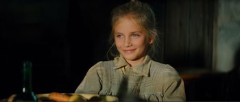 Movie still from “Jean de Florette” (1986), directed by Claude Berri – A young girl is sitting in front of a bunch of apples; Close Up shot, Over the shoulder angle