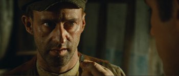 Movie still from “Jean de Florette” (1986), directed by Claude Berri – A person holding a piece of metal; Close Up shot, Over the shoulder angle