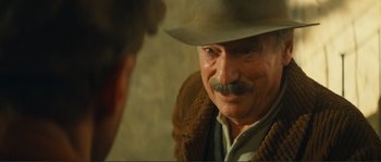 Movie still from “Jean de Florette” (1986), directed by Claude Berri – An older man with a mustache and a hat; Close Up shot, Over the shoulder angle