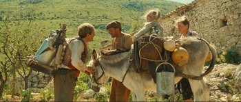 Movie still from “Jean de Florette” (1986), directed by Claude Berri – Two men and a girl on a donkey in a field; Wide shot, Low angle
