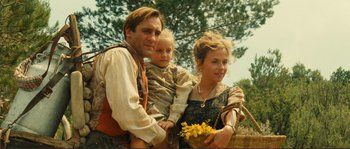 Movie still from “Jean de Florette” (1986), directed by Claude Berri – A man , woman , and a child pose for a picture; Medium shot, Low angle
