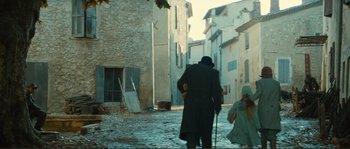 Movie still from “Jean de Florette” (1986), directed by Claude Berri – An old man walking down the street with a cane; Wide shot, Low angle