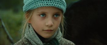 Movie still from “Jean de Florette” (1986), directed by Claude Berri – A young girl wearing a hat; Close Up shot, Over the shoulder angle