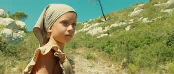 Movie still from “Jean de Florette” (1986), directed by Claude Berri – A young girl wearing a headscarf standing on top of a hill; Close Up shot, Low angle