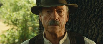Movie still from “Jean de Florette” (1986), directed by Claude Berri – An old man with a mustache wearing a hat; Close Up shot, Low angle