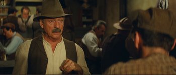 Movie still from “Jean de Florette” (1986), directed by Claude Berri – An old man with a mustache wearing a hat; Close Up shot, Over the shoulder angle