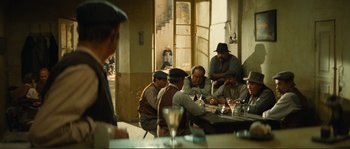 Movie still from “Jean de Florette” (1986), directed by Claude Berri – A group of men sitting at a table with drinks; Wide shot, High angle