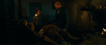 Movie still from “Jean de Florette” (1986), directed by Claude Berri – A group of people standing next to a dead body; Wide shot, High angle