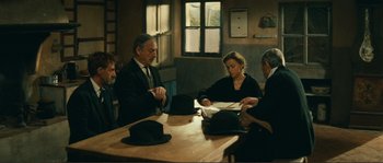 Movie still from “Jean de Florette” (1986), directed by Claude Berri – A group of people sitting around a table; Wide shot, Over the shoulder angle