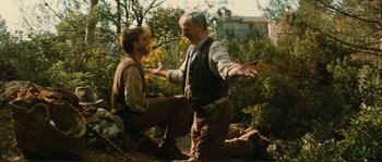 Movie still from “Jean de Florette” (1986), directed by Claude Berri – Two men are talking in the woods; Medium shot, Low angle