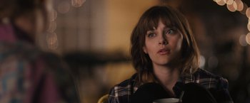 Movie still from “Jem and the Holograms” (2015), directed by Jon M. Chu – A person sitting in a room with a cup; Close Up shot, Over the shoulder angle