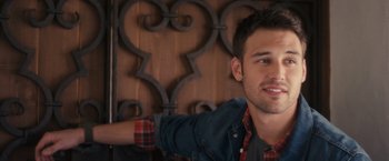 Movie still from “Jem and the Holograms” (2015), directed by Jon M. Chu – A young man in a plaid shirt and denim jacket; Close Up shot, Over the shoulder angle