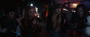 Movie still from “Jem and the Holograms” (2015), directed by Jon M. Chu – Two young women standing next to each other on a street; Medium shot, Over the shoulder angle